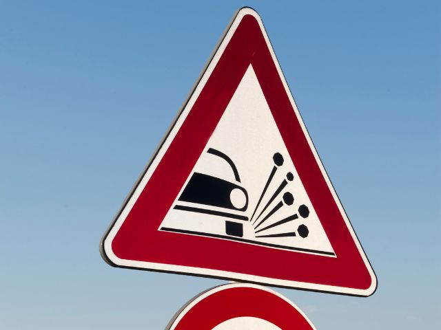Road sign with image of car and splashing water.
