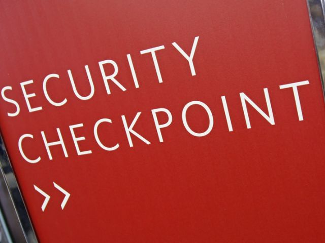 Red security checkpoint sign.
